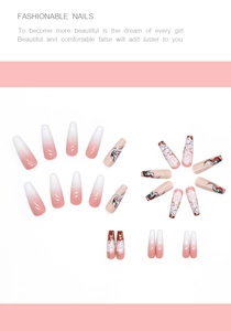 Detail of long coffin press-on nails with pink gradient and hand-painted floral designs