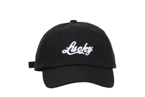 Close-up of white 3D Lucky embroidery on a black cotton twill baseball cap