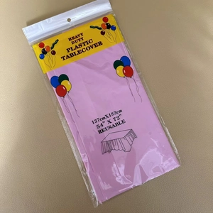 Close-up of pink disposable PE plastic tablecloth 137x183cm in original packaging