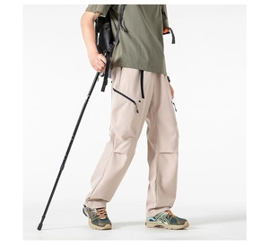 Detail of khaki cargo pants featuring waterproof zippers and functional multi-pockets design