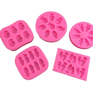 Pink silicone carrot molds for fondant and cake decoration on white background