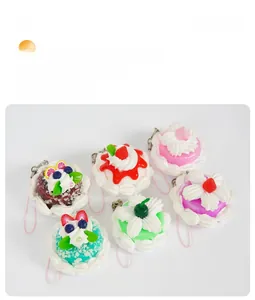 Set of six colorful miniature cake charms with detailed fruit toppings and pink lanyards