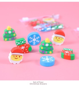 Close-up of four Christmas erasers in Santa, tree, snowflake, and sock shapes