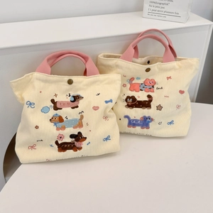Détail de sacs à lunch en velours côtelé avec broderie mignonne et poignées en sangle rose