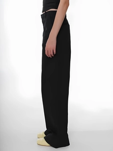 Side view of black straight-leg trousers with elegant drape and minimalist style