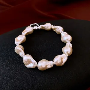 Baroque irregular pearl beaded bracelet with silver magnetic clasp on black background