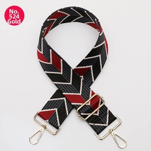 Detail of adjustable geometric woven strap with gold metal hooks for shoulder bags