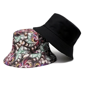 Reversible bucket hat with abstract colorful pattern and minimalist solid black side