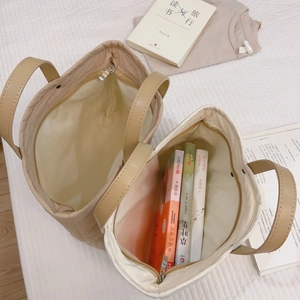 Quilted beige and khaki tote bags with large capacity on a cozy checkered bed setting