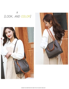 Detail view of the brown checkerboard tote bag with premium leather handles and shoulder strap