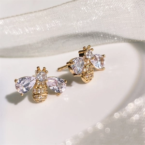 Exquisite gold bee stud earrings with teardrop cubic zirconia on a white ribbon