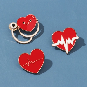 Macro detail of three medical-themed metal enamel pins on a blue background