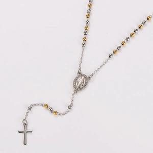 Detailed view of two-tone gold and silver beaded rosary necklace with cross and Virgin Mary medal