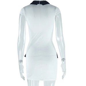 Detail view of the slim-fit white dress featuring a black contrast collar and back zipper