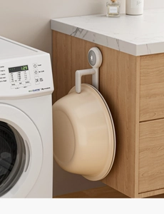 Close-up of a white wall-mounted washbasin hook with PUSH design for easy storage