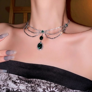 Elegant silver layered choker necklace with emerald green gemstones and sparkling rhinestones