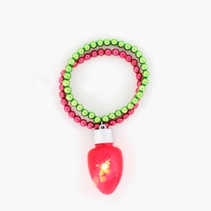 Detail of Christmas necklace with red and green beads and glowing LED bulb pendant