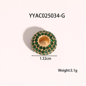 Detailed view of a 1.32cm gold heart pendant with green gems for jewelry making