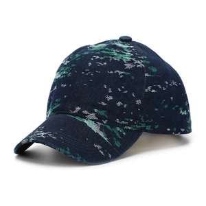 Detail of navy blue jacquard baseball cap with green camo pattern and stitched brim