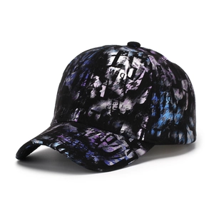 Detailed view of black baseball cap with metallic silver and purple graffiti print texture