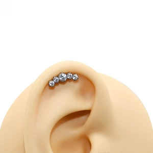 Silver G23 titanium labret stud with five sparkling zircons on a realistic ear model