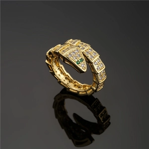 Snake wrap ring in 18K gold plated copper with white cubic zirconia and green eyes