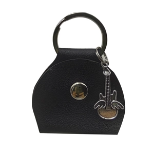 Close-up of black lychee texture leather plectrum case with a winged guitar metal charm