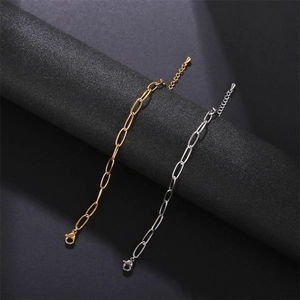 Detailed view of gold and silver stainless steel chain bracelets with lobster clasps