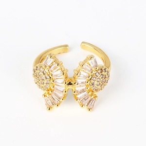 Detail of gold-plated butterfly ring featuring micro-paved white cubic zirconia stones