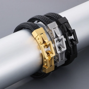 Detailed macro view of woven leather bracelets with silver, gold, and black steel magnetic clasps