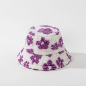 Close-up of plush bucket hat featuring purple floral patterns and soft fleece texture