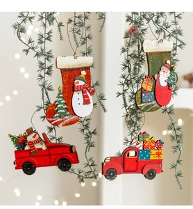 Detail of wooden Christmas ornaments featuring snowmen and Santa on festive socks and trucks
