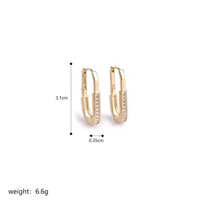 Detailed size view of gold U-shaped twist earrings with shimmering inset diamonds