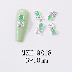 Detail showing 6x10mm mint green cat-eye butterfly nail art charm with silver base