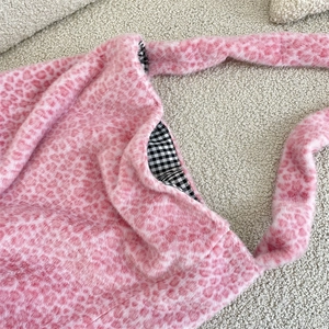 Detail of pink leopard plush tote showing soft faux fur texture and checkered lining