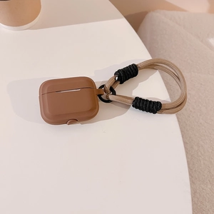 Detail view of brown silicone case for AirPods with beige and black braided hand strap