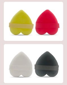 Set of four heart-shaped velvet makeup puffs in yellow, red, white and black colors