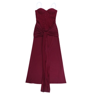 Detail of dark red evening dress featuring lace stitching and decorative waist streamers