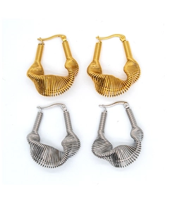 Detail shot of multi-layered spiral texture on gold and silver stainless steel earrings