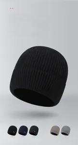 Detailed view of six colors of ribbed knit beanies with stitched logo labels