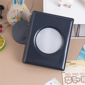 Detail of dark grey glitter photocard album with circular window and metal ball chain