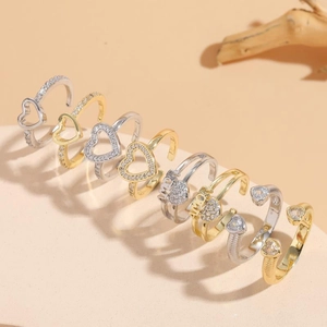 Adjustable zircon rings in gold and silver finish featuring hollow hearts and AMOR text