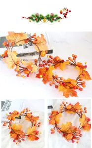Detail of harvest candle ring featuring maple leaves, foam berries and mini pumpkins