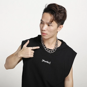 Close-up of a man wearing a thick silver curb chain necklace and simple steel ring