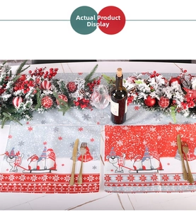 Detail of Christmas table set with snowflake runner and Santa gnome placemats
