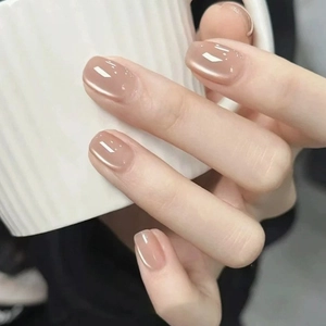 Short oval nude pink cat eye press on nails with glossy pearl finish for a natural look