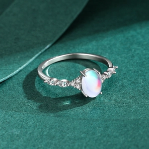 S925 sterling silver moonstone ring with marquise zirconia accents on a green backdrop