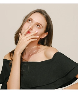 Model wearing minimalist 925 sterling silver moissanite rings on fingers in soft light