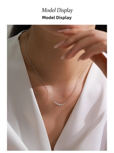 Elegant S925 silver curved pendant necklace with zircon stones worn by a model