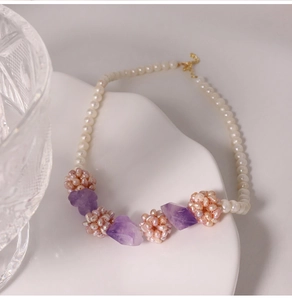Detail of freshwater pearl necklace with amethyst stones and woven pink pearl balls